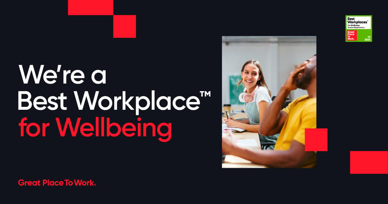 Text that reads: "We're a best workplace for Wellbeing" on a black background with a portrait picture of two colleagues laughing together.