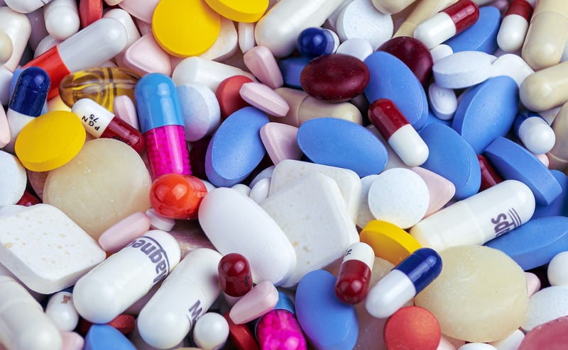 An assortment of different tablets and capsules, all of medicines.
